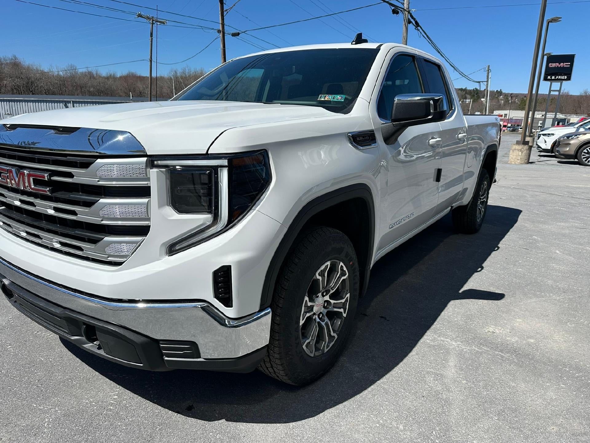 2026 GMC Sierra 1500 SLE in Summit White — front three-quarter view