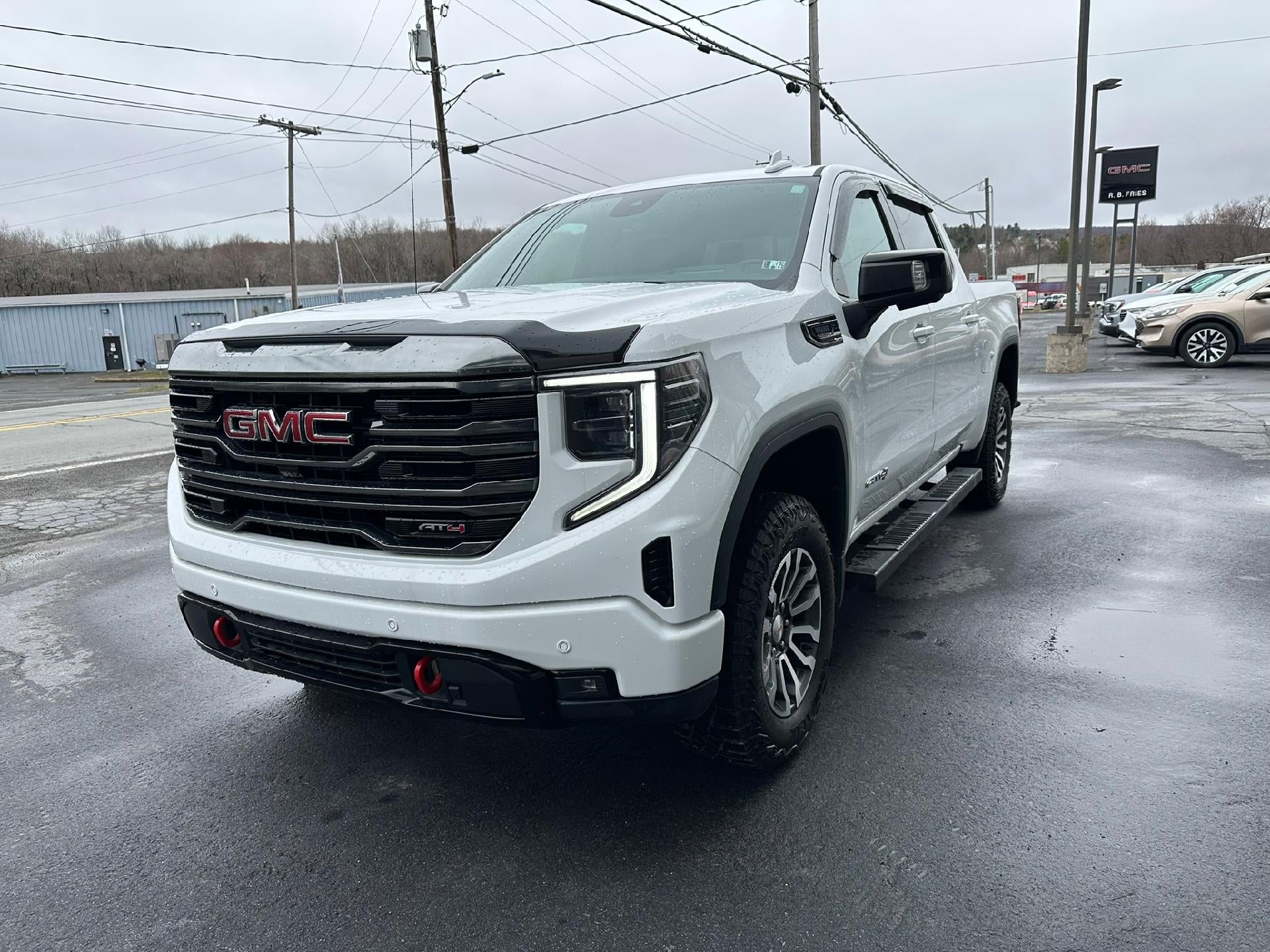 2023 GMC Sierra 1500 AT4 in Summit White — front three-quarter view